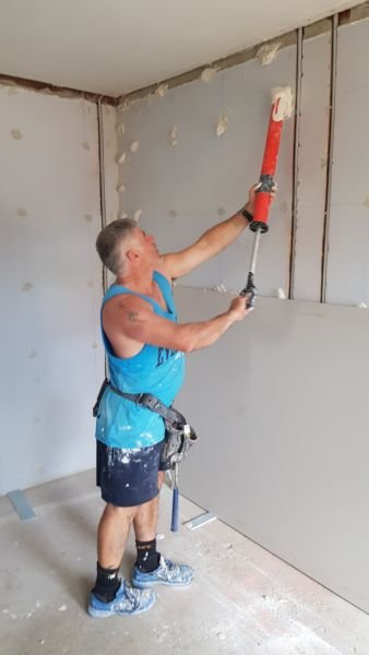 Paul from pauls plastering dry lining a wall