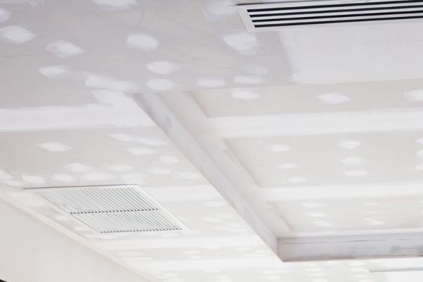 dropped ceiling in this sydney home hides utilities like air con vents and electrical cables