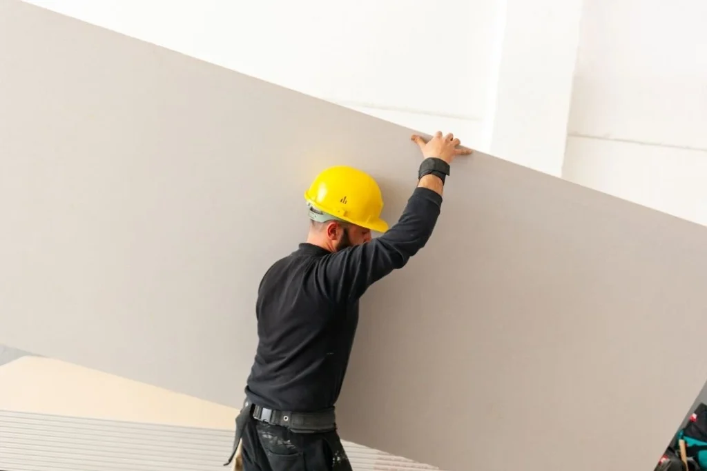 Carrying a plasterboard for installation